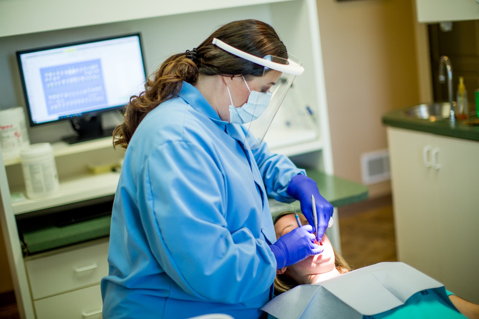 Staff member holding a dental model